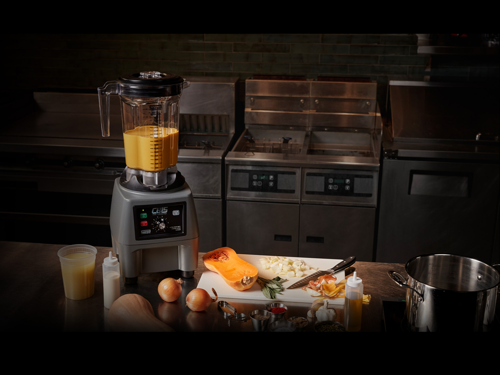 Blender with drink and food on table | Waring